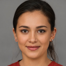 Joyful white young-adult female with medium  brown hair and brown eyes