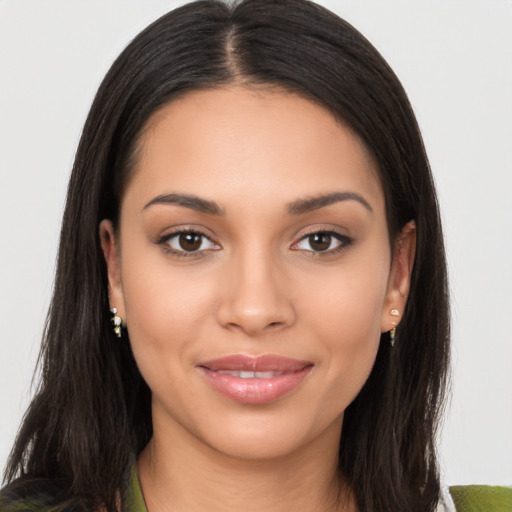 Joyful latino young-adult female with long  brown hair and brown eyes