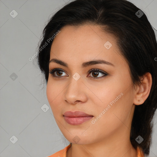 Joyful latino young-adult female with medium  brown hair and brown eyes