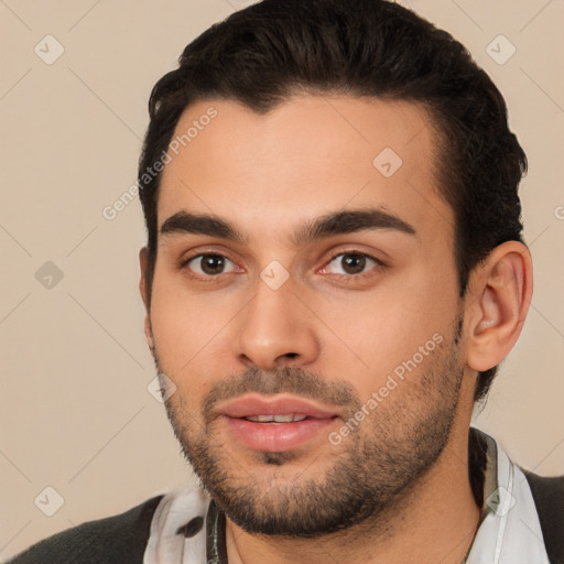 Joyful white young-adult male with short  black hair and brown eyes