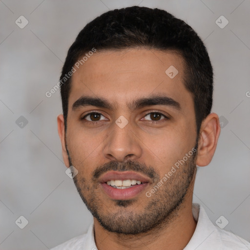 Joyful latino young-adult male with short  black hair and brown eyes