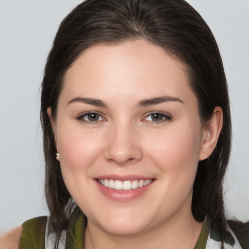 Joyful white young-adult female with medium  brown hair and brown eyes