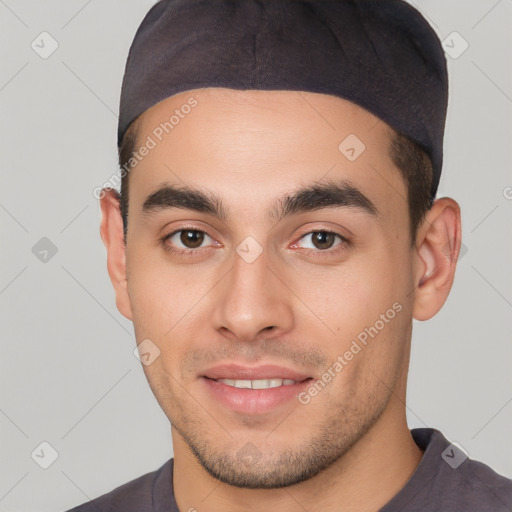 Joyful white young-adult male with short  black hair and brown eyes