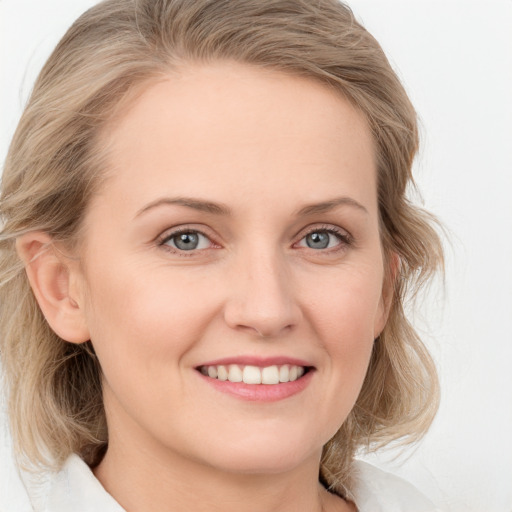 Joyful white young-adult female with medium  brown hair and blue eyes