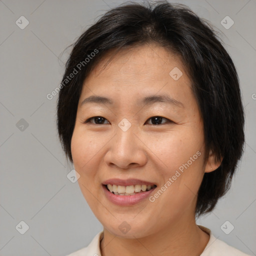 Joyful asian adult female with medium  brown hair and brown eyes