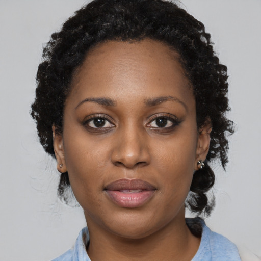 Joyful black young-adult female with medium  black hair and brown eyes