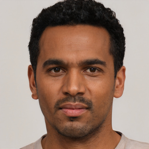 Neutral black young-adult male with short  black hair and brown eyes