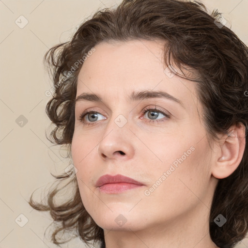 Joyful white young-adult female with medium  brown hair and green eyes