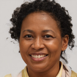 Joyful black adult female with short  brown hair and brown eyes