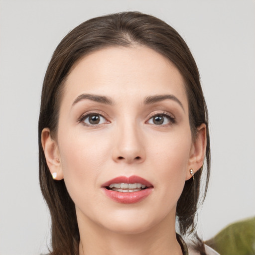 Joyful white young-adult female with medium  brown hair and grey eyes