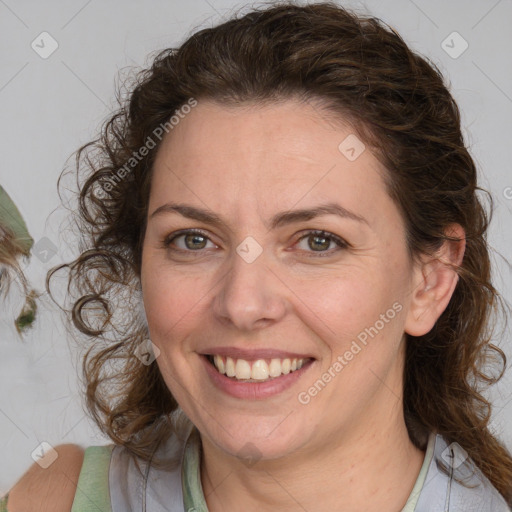 Joyful white adult female with medium  brown hair and blue eyes