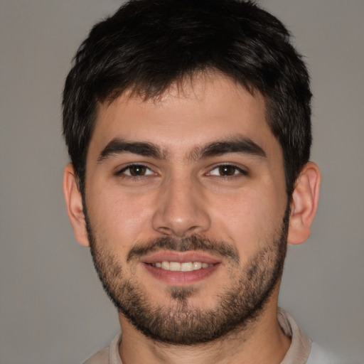 Joyful white young-adult male with short  brown hair and brown eyes