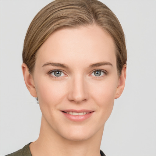 Joyful white young-adult female with short  brown hair and grey eyes