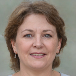 Joyful white adult female with medium  brown hair and grey eyes