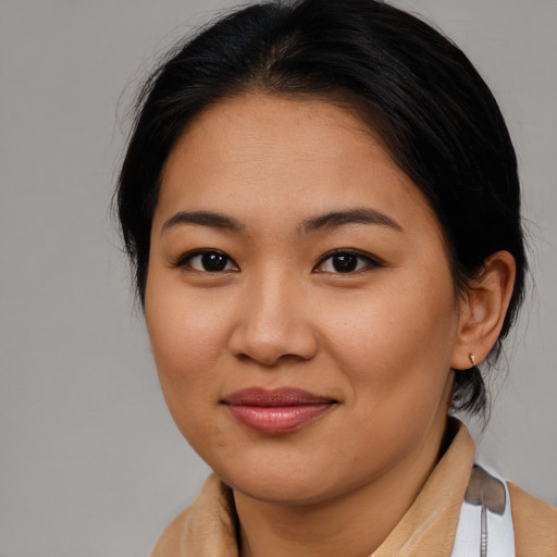 Joyful asian young-adult female with medium  brown hair and brown eyes