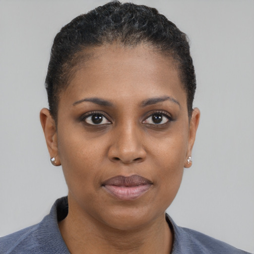 Joyful black young-adult female with short  brown hair and brown eyes