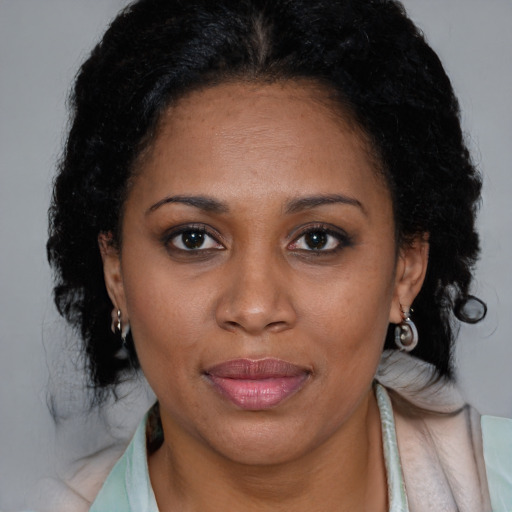 Joyful black young-adult female with medium  brown hair and brown eyes