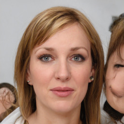 Joyful white young-adult female with medium  brown hair and blue eyes