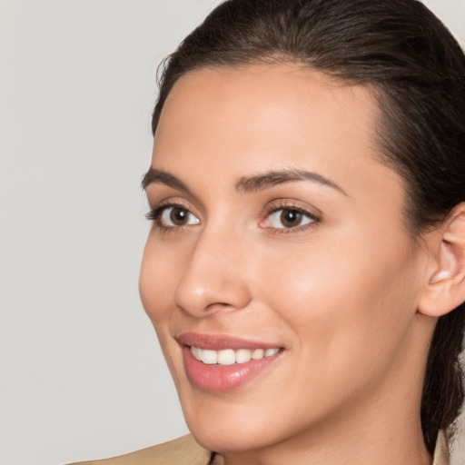 Joyful white young-adult female with medium  brown hair and brown eyes