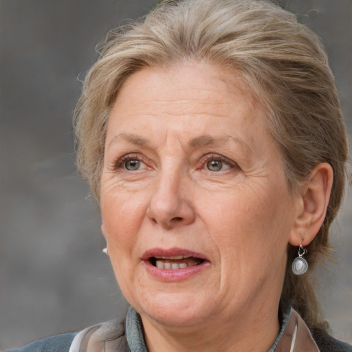 Joyful white middle-aged female with medium  brown hair and grey eyes