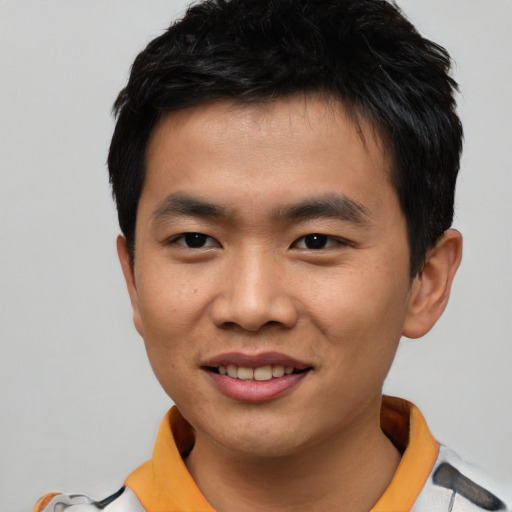 Joyful asian young-adult male with short  black hair and brown eyes