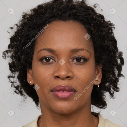 Joyful black adult female with medium  brown hair and brown eyes