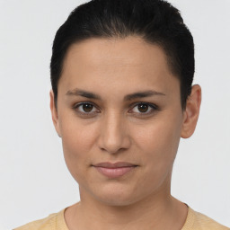 Joyful latino young-adult female with short  black hair and brown eyes