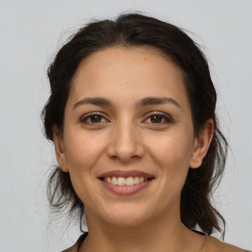 Joyful white young-adult female with medium  brown hair and brown eyes