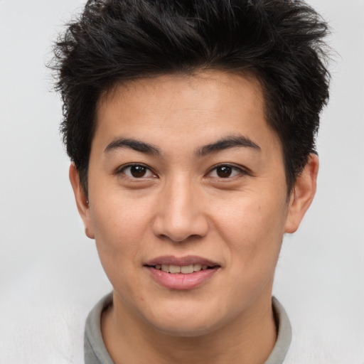 Joyful asian young-adult male with short  brown hair and brown eyes