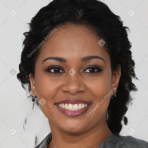 Joyful black young-adult female with long  brown hair and brown eyes