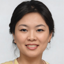Joyful asian young-adult female with medium  brown hair and brown eyes