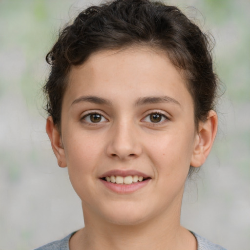 Joyful white child female with short  brown hair and brown eyes