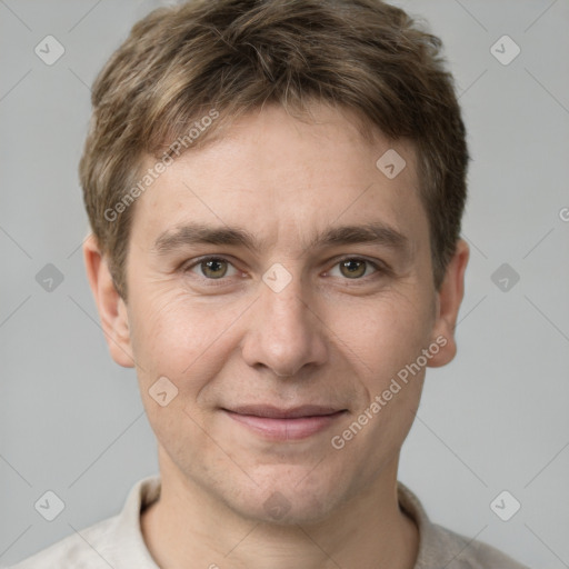 Joyful white adult male with short  brown hair and grey eyes