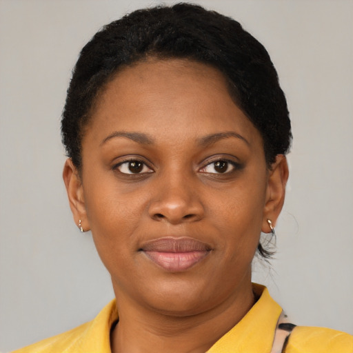 Joyful black young-adult female with short  brown hair and brown eyes
