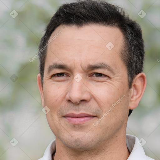 Joyful white adult male with short  brown hair and brown eyes