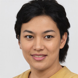 Joyful asian young-adult female with short  brown hair and brown eyes
