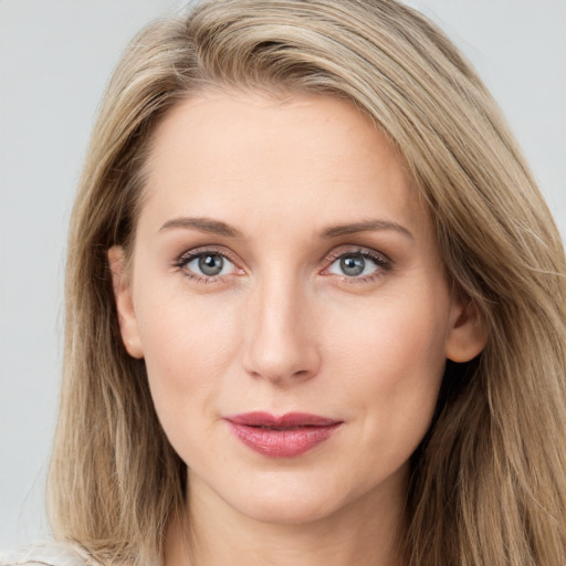 Joyful white young-adult female with long  brown hair and blue eyes