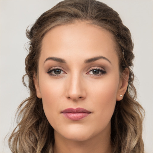 Joyful white young-adult female with long  brown hair and brown eyes