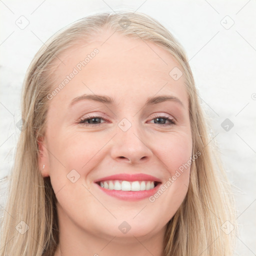 Joyful white young-adult female with long  brown hair and blue eyes