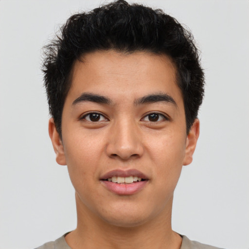 Joyful asian young-adult male with short  brown hair and brown eyes