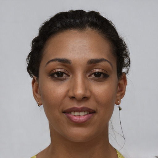 Joyful latino young-adult female with short  brown hair and brown eyes