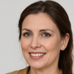 Joyful white adult female with long  brown hair and brown eyes