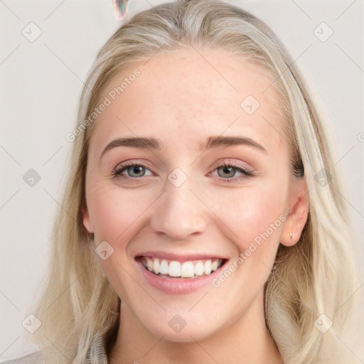 Joyful white young-adult female with long  brown hair and blue eyes