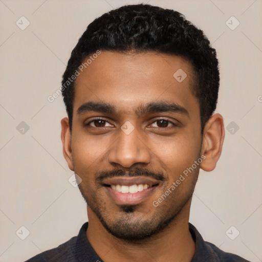 Joyful black young-adult male with short  black hair and brown eyes