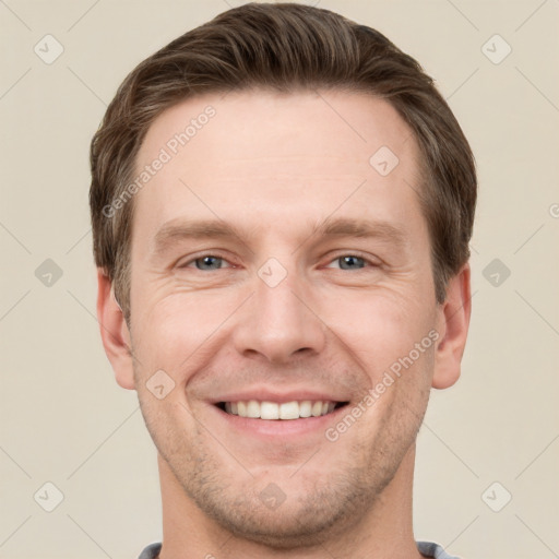 Joyful white young-adult male with short  brown hair and grey eyes