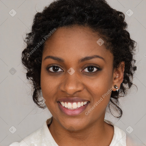 Joyful black young-adult female with long  brown hair and brown eyes