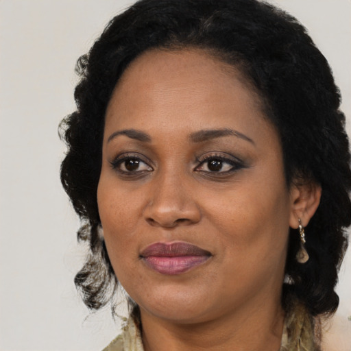 Joyful black adult female with medium  black hair and brown eyes
