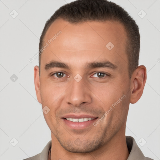 Joyful white young-adult male with short  brown hair and brown eyes