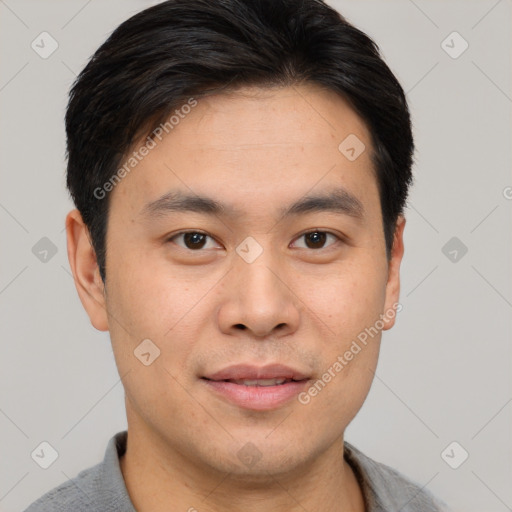 Joyful asian young-adult male with short  black hair and brown eyes