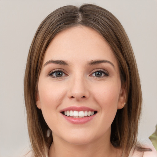 Joyful white young-adult female with medium  brown hair and green eyes